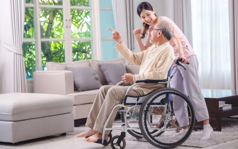 Elderly care helper assisting an aging parent at home
